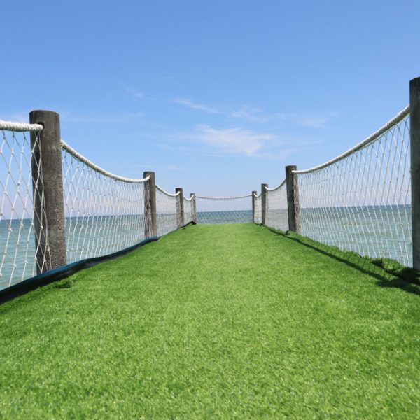 synthetic grass on a wooden bridge at the beachside pier