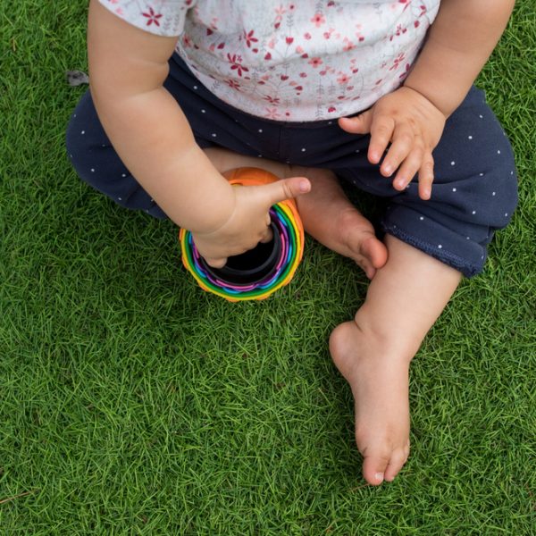 Small kid sits on the grass